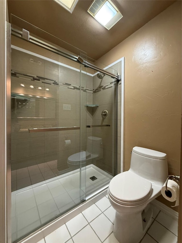 full bathroom featuring toilet, a shower stall, visible vents, and tile patterned floors