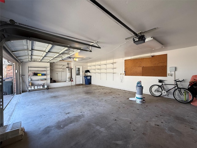 garage featuring gas water heater and a garage door opener