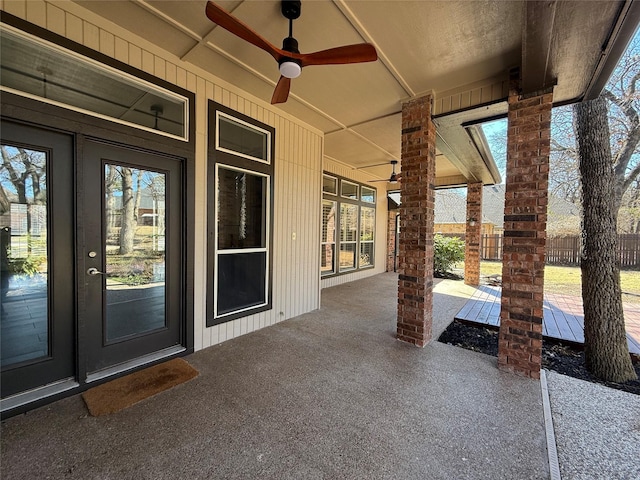 view of patio with a ceiling fan and fence