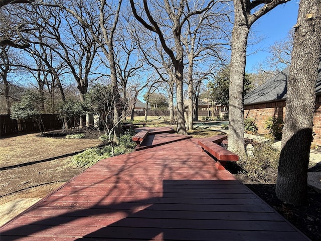 wooden terrace featuring fence