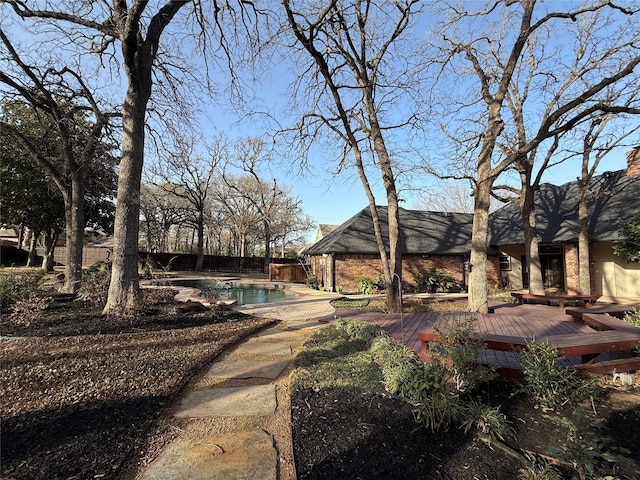 exterior space with fence and a deck