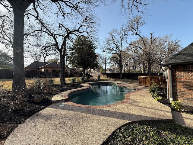 pool with a patio, a fenced backyard, and a jacuzzi