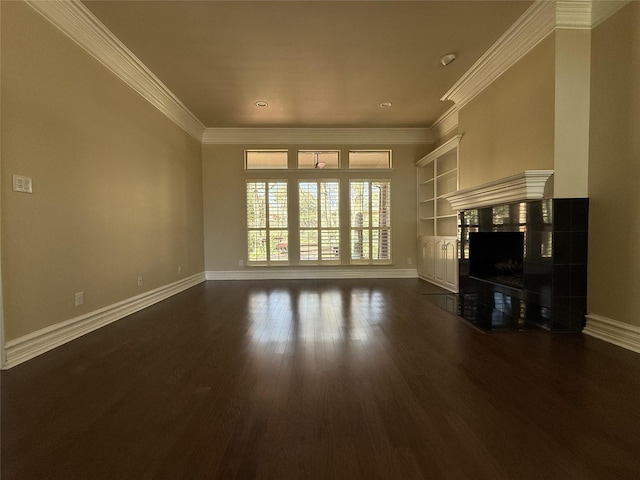 unfurnished living room featuring crown molding, a high end fireplace, dark wood finished floors, and baseboards