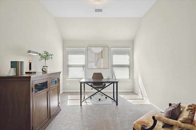 office space with light carpet, a healthy amount of sunlight, and vaulted ceiling