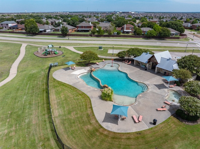 view of swimming pool featuring a patio and a residential view