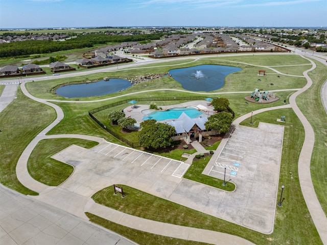 drone / aerial view featuring a water view and a residential view