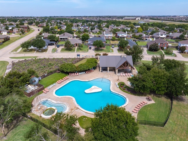 community pool with a patio area, a residential view, and fence