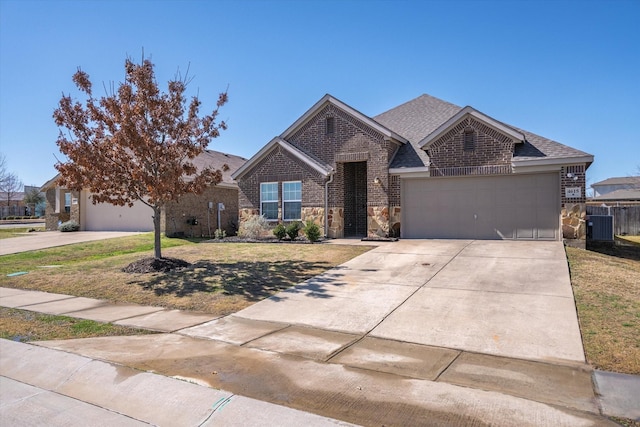 single story home featuring driveway, an attached garage, a front lawn, and brick siding