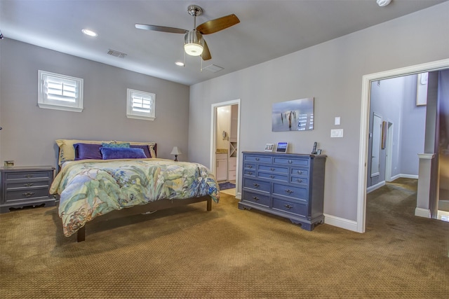 bedroom with visible vents, ensuite bathroom, a ceiling fan, carpet flooring, and baseboards