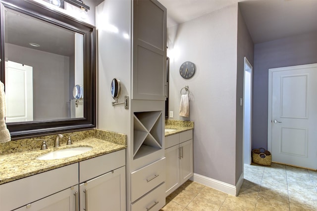 bathroom featuring tile patterned floors, vanity, and baseboards