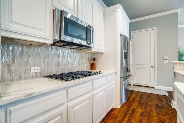 kitchen featuring crown molding, appliances with stainless steel finishes, backsplash, and white cabinets