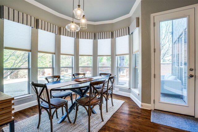 dining room featuring baseboards, ornamental molding, and dark wood-style flooring