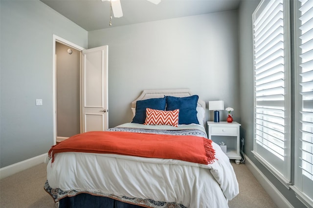 carpeted bedroom featuring ceiling fan and baseboards