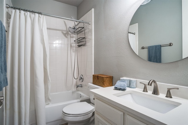 bathroom featuring shower / tub combo, a textured wall, vanity, and toilet