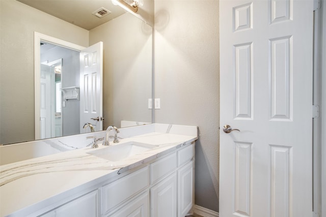 bathroom featuring visible vents and vanity