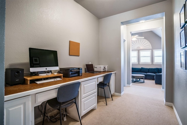 office with light carpet, built in study area, a ceiling fan, and baseboards