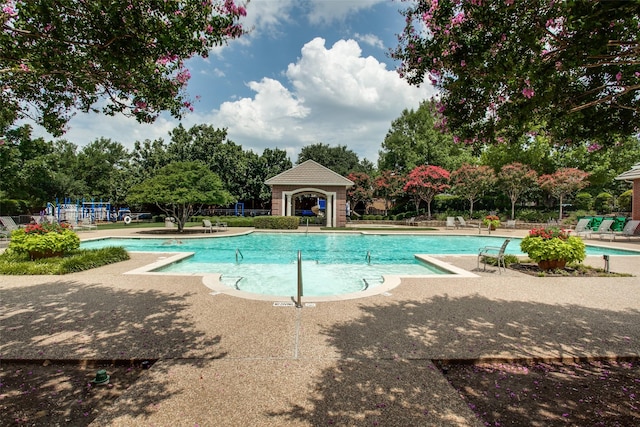 community pool featuring a patio area and fence