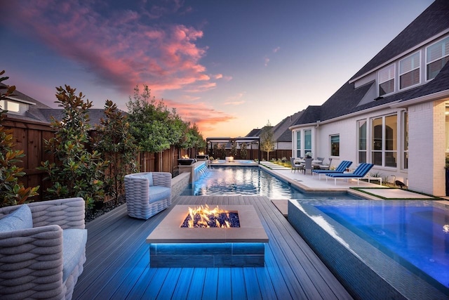 view of pool featuring a fenced in pool, an outdoor fire pit, a fenced backyard, and a hot tub