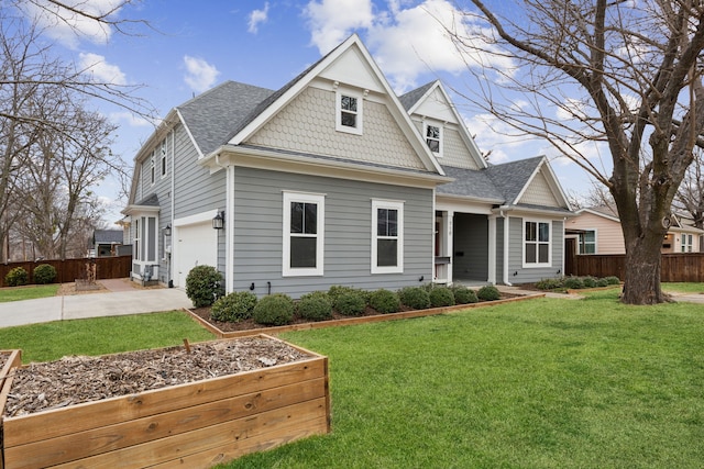 view of front of property with concrete driveway, a front lawn, roof with shingles, and fence