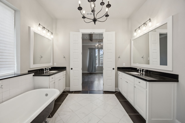 bathroom with tile patterned floors, a sink, visible vents, and an inviting chandelier