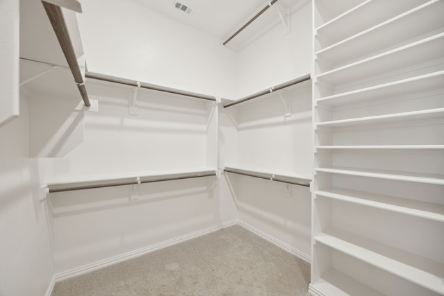 walk in closet featuring carpet flooring and visible vents