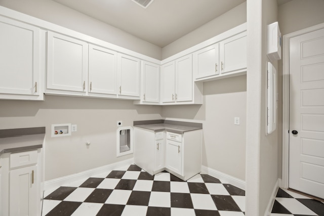 clothes washing area with dark floors, washer hookup, baseboards, cabinet space, and electric dryer hookup