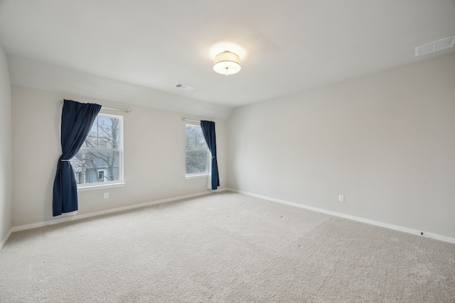 carpeted empty room with visible vents and baseboards