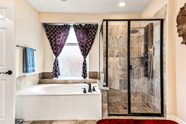 bathroom featuring a garden tub and a shower stall