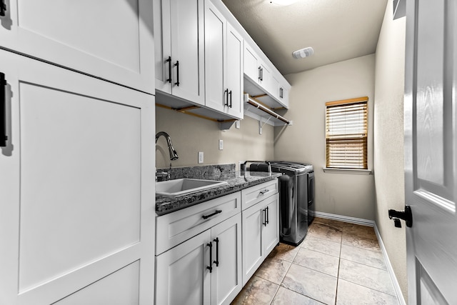 clothes washing area with light tile patterned floors, a sink, visible vents, cabinet space, and washing machine and clothes dryer