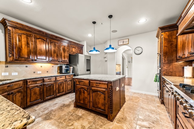 kitchen featuring smart refrigerator, tasteful backsplash, arched walkways, and decorative light fixtures