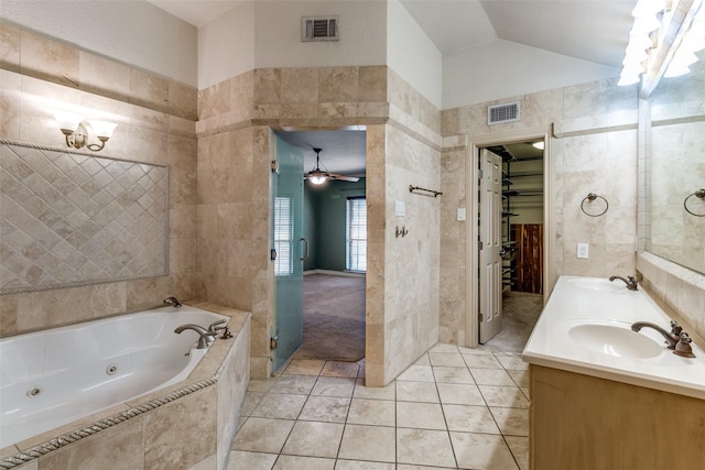 bathroom featuring vaulted ceiling, a sink, visible vents, and tile walls