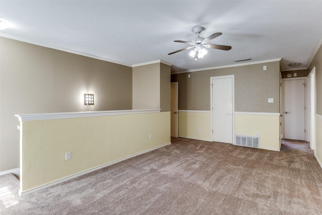 unfurnished room featuring ornamental molding, visible vents, and carpet flooring