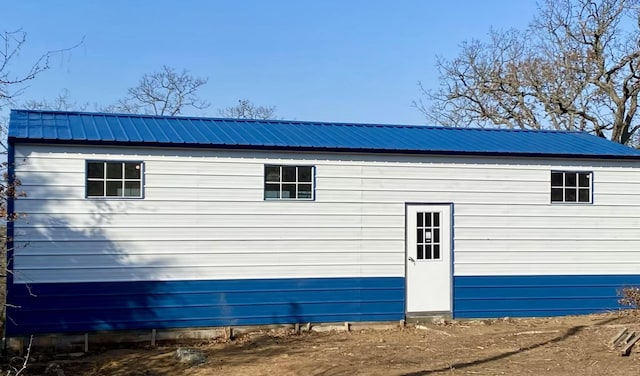 view of property exterior featuring metal roof