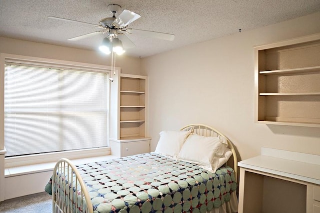 bedroom with a textured ceiling and ceiling fan