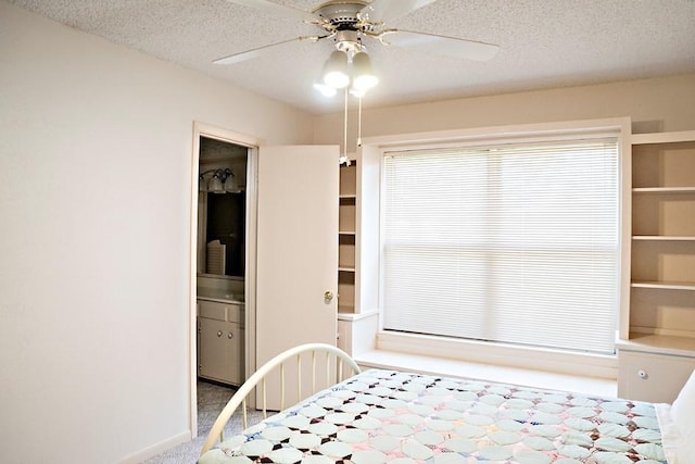 unfurnished bedroom with carpet floors, ceiling fan, baseboards, and a textured ceiling