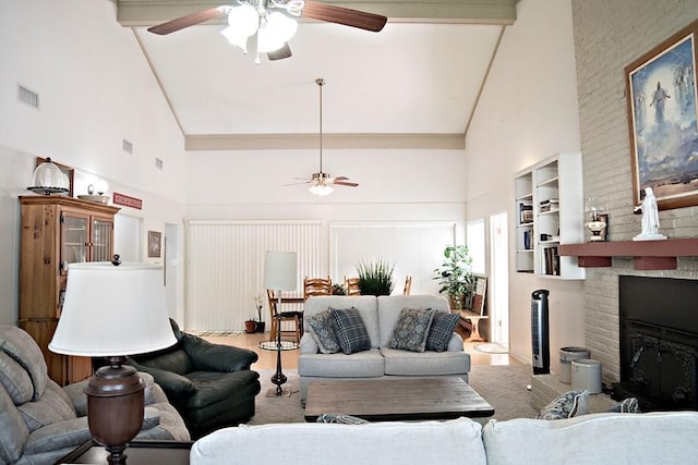 living area with high vaulted ceiling, a brick fireplace, visible vents, and a ceiling fan