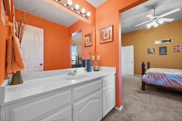 bathroom with ceiling fan, vanity, and baseboards