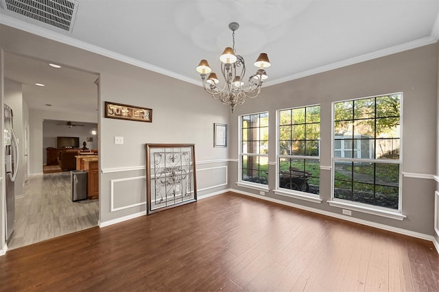 unfurnished dining area featuring dark wood-style flooring, visible vents, and crown molding