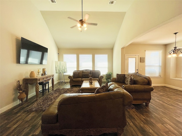 living area with lofted ceiling, visible vents, baseboards, and dark wood-style flooring