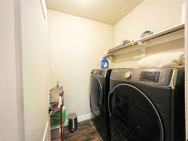 washroom featuring laundry area, separate washer and dryer, wood finish floors, and baseboards