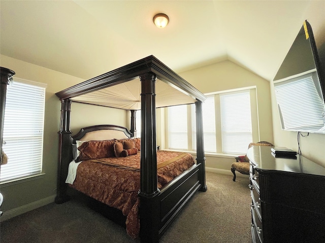 carpeted bedroom with lofted ceiling and baseboards