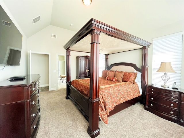 bedroom featuring lofted ceiling, light carpet, and visible vents