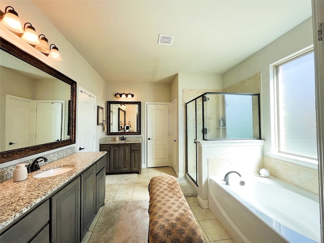 bathroom featuring visible vents, a stall shower, a sink, tile patterned flooring, and a bath