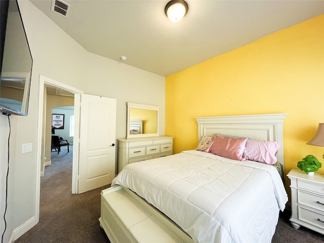 bedroom featuring arched walkways, dark carpet, and visible vents