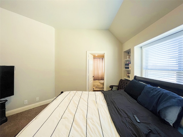 bedroom with lofted ceiling, carpet floors, ensuite bath, and baseboards