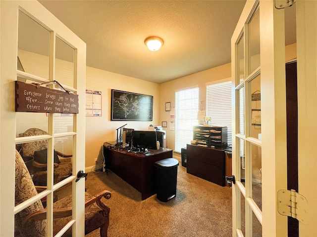 home office with french doors, carpet flooring, and a textured ceiling