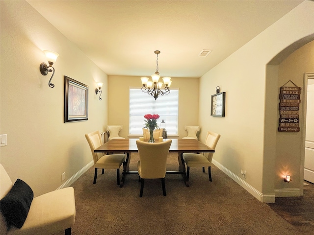 dining space with visible vents, dark carpet, baseboards, and an inviting chandelier