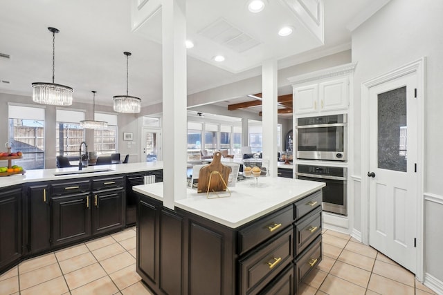 kitchen with light tile patterned floors, stainless steel double oven, light countertops, and a sink