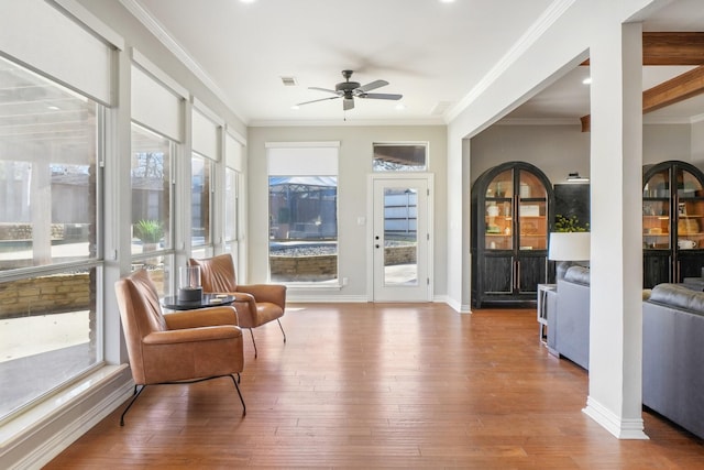 sunroom featuring visible vents and ceiling fan