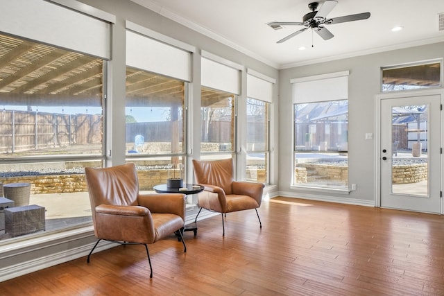 sunroom / solarium with visible vents and a ceiling fan